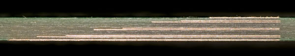 Photo of a cross section of the PCB showing the copper layers.
