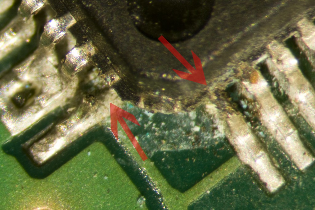 Microscope photo of pins 100 (left) and 1 (right). Pin 1 is narrower than the other pins.